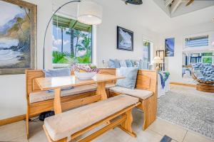a dining room with a table and chairs at Paniolo #202 A & B in Princeville