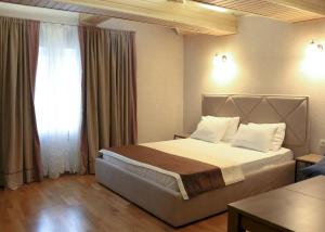 a bedroom with a large bed and a window at BestKievApartment in Kyiv