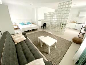 a living room with a couch and a table at Villamartin Hotel GHB in Orihuela Costa