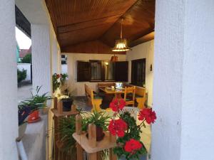 a porch with a table and flowers on it at Royal Rose smeštaj in Bela Crkva