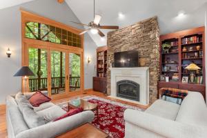 a living room with two couches and a fireplace at Falling Waters at Rumbling Bald in Lake Lure