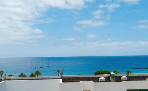 a view of the ocean from the balcony of a resort at AZAHARA PLAYA LAS VISTAS - STUDIO - Playa de Las Americas in Playa de las Americas