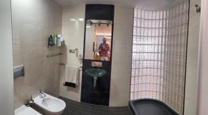 a bathroom with a sink and a toilet and a mirror at Apartamento Elobey Cabo de Gata in El Cabo de Gata