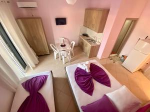 Postel nebo postele na pokoji v ubytování Hotel Vila Ali