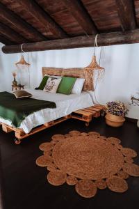 a bedroom with a bed with a wooden frame and a rug at Monte do Pomar in Redondo +50 photos