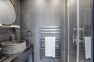 a bathroom with a sink and a shower at Castel Saint Clair - Trois Pièces - Deauville Centre in Deauville