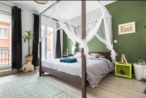 sypialnia z łóżkiem z baldachimem i zielonymi ścianami w obiekcie Apt A Africa, 30m2, Centre, Balcon w mieście Valenciennes