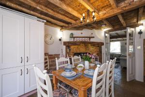 a dining room with a table and chairs and a fireplace at Joe's Cottage in Bridgnorth