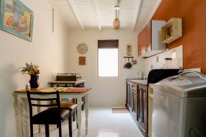 a small kitchen with a table and a table and a dishwasher at Rústic-HOUSE Envigado in Envigado
