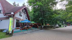 a building with a flower market in front of it at Pensiunea Happy Inn in Vatra Dornei