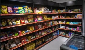 a store shelf filled with lots of different types of food at Trend Nova Carlos Gomes - 406 in Porto Alegre