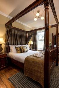 a bedroom with a canopy bed and a window at Blackfriars Residence - Beautiful Home in Edinburgh