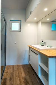 a bathroom with a sink and a counter top at Lubiatowe Love - domki w otulinie lasu in Lubiatowo +43 photos
