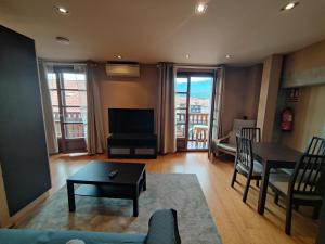 a living room with a couch and a table at Apartamentos Calle Mayor 23 Llanes in Llanes