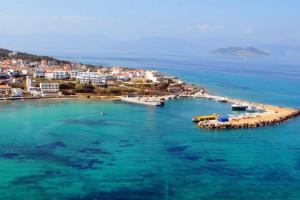 a beach with a group of people in the water at A View Home _ Agkistri in Megalochori +11 photos