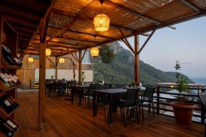 a restaurant with tables and chairs and a view at Tree Houses Hotel in Fethiye