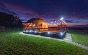 a large dome building in a field at night at The Dome Breaza (BV) in Breaza