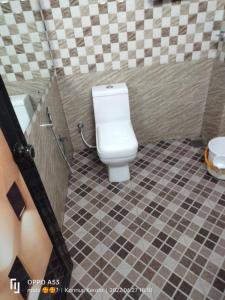 a bathroom with a toilet and a sink at CHILLAX Resorts Palakkayam THATTU in Paithalmala