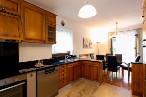 a kitchen with wooden cabinets and a dining room at Casa Lilly in Labin