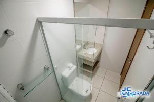 a bathroom with a toilet and a glass shower at Riviera Park in Caldas Novas