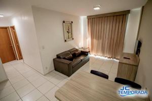 a living room with a couch and a table at Riviera Park in Caldas Novas