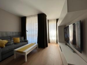 a living room with a couch and a tv at Apartament Bastion Wałowa Gdańsk in Gdańsk