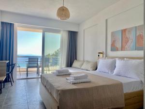 a bedroom with a bed and a view of the ocean at Elanthi in Skala Potamias