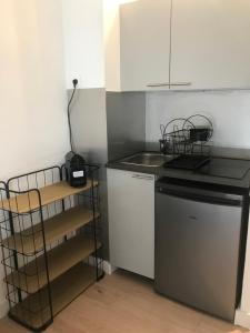 a small kitchen with a sink and a dishwasher at Studio 2 adultes 2 enfants Sanary sur Mer à 800m de la mer in Sanary-sur-Mer +9 photos