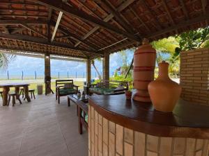 a patio with tables and vases on top of it at Morada da Praia - Porto de Pedras à Beira-Mar in Pôrto de Pedras