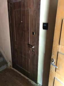 a wooden door in the corner of a room at R.Wolf castle in Gulbene +5 photos