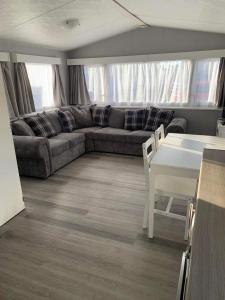 a living room with a couch and a table at Alberta holiday park in Whitstable