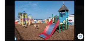 a playground with a slide in a park at Alberta holiday park in Whitstable