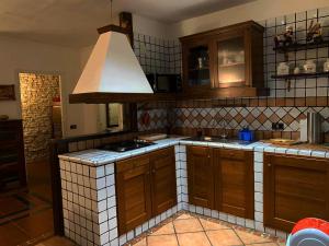 a kitchen with wooden cabinets and a stove top oven at Fiocco di neve in Roccaraso