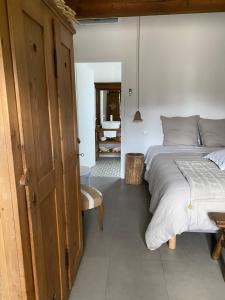 a bedroom with a large bed and a bathroom at OSTAL 158 in Le Barp