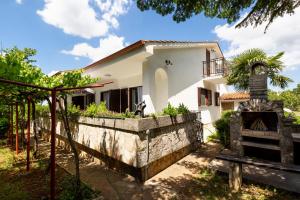 a house with a stone retaining wall and a fireplace at Casa Lilly in Labin