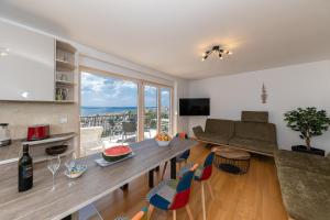 a living room with a table and a couch at Penthaus Lukic Crikvenica in Crikvenica