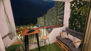 a balcony with a table and a couch on a building at Vista Mar in Empuriabrava