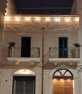 a building with two balconies and a wooden door at Mivigio in Bari