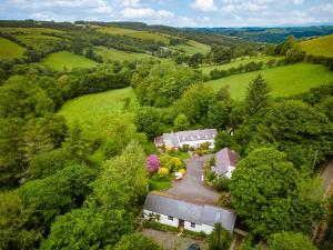 an aerial view of a house in a green field at Brynarth Country Cottages in Aberystwyth