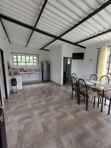 a kitchen and dining room with a table and chairs at CASALOMA in La Vega