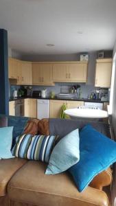 a living room with a couch and a kitchen at Galway City Lovely 2 Bed Apartment in Galway