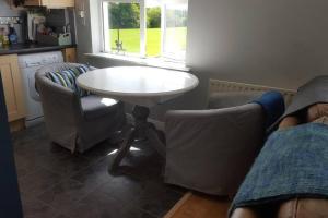 a kitchen with a table and chairs and a table and a window at Galway City Lovely 2 Bed Apartment in Galway