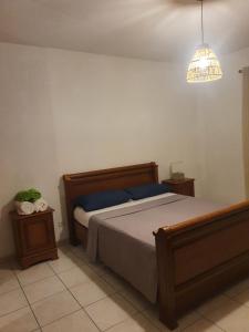 a bedroom with a bed and a pendant light at La villa d elisa in Leucate +11 photos