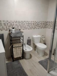a bathroom with a toilet and a sink at Casa Eduardo 1 in El Puente +23 photos