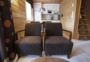 a kitchen with two chairs and a table in a room at Keurusharju Apartments in Keuruu