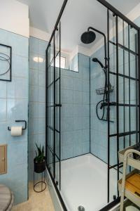 een badkamer met een douche met blauwe tegels bij Sun x Mountains - Strada Sforii in Braşov
