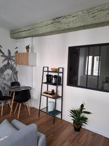 a living room with a couch and a table at échappée belle en plein cœur d auxerre in Auxerre