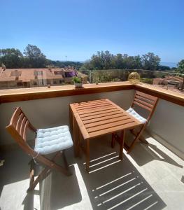 a wooden table and two chairs on a balcony at Ocean view, Luxury & Relax Dunas de Artola in Marbella
