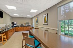 a large kitchen with a large table and chairs at Best Western Hendersonville Inn in Hendersonville