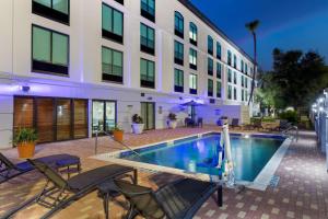 a swimming pool in front of a building at Best Western Plus McAllen Airport Hotel in McAllen